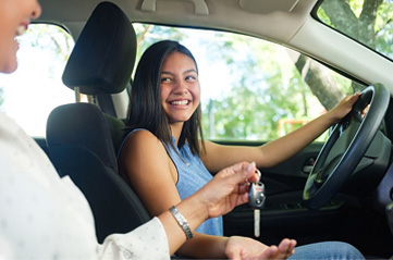 Woman handing keys to the driver