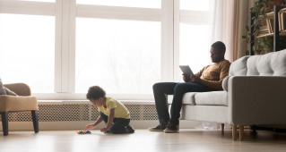 A father and son relaxing in the living room