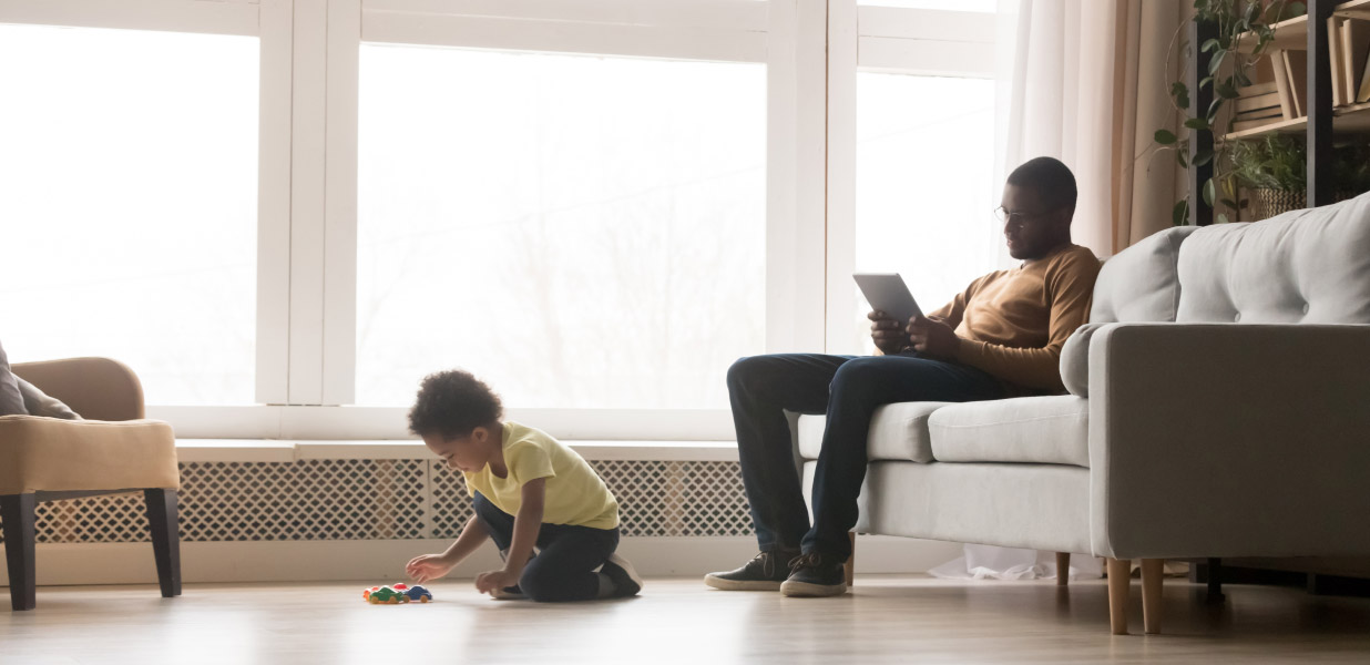 A father and son relaxing in the living room