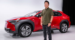 Subaru's Garrick Goh standing in front of a red Subaru Solterra