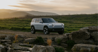 Rivian's latest electric mid-size SUV, the R2, parked in the wilderness