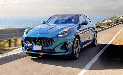 A Maserati Grecale Folgore driving on coastal highway